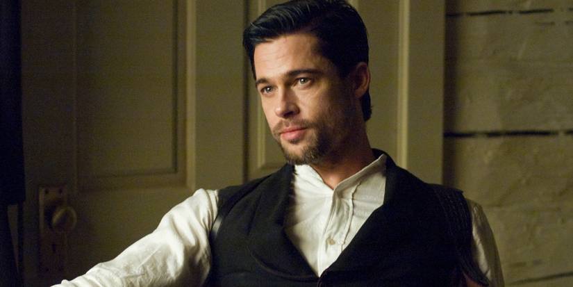 Brad Pitt as Jesse James sitting in a chair in The ᴀssᴀssination of Jesse James by the Coward Robert Ford.