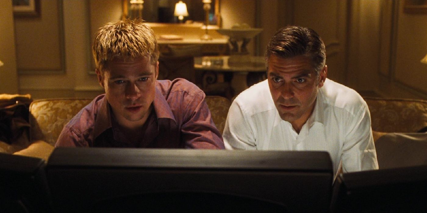 Brad Pitt as Ryan and George Clooney as Danny looking at a computer in Ocean's Eleven