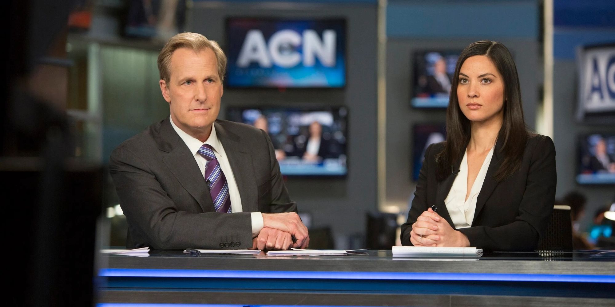 Will & Sloan Sitting At The News Desk In The Newsroom.jpg