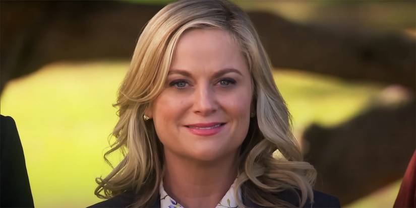 Leslie Knope (Amy Poehler) smiling into the distance in Parks and Rec's final scene.