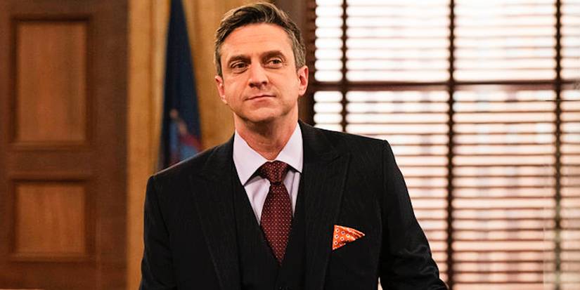 Barba standing with a confident smirk in Law & Order: SVU
