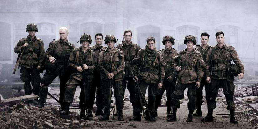 soldiers standing next to each other in a battlefield in band of brothers