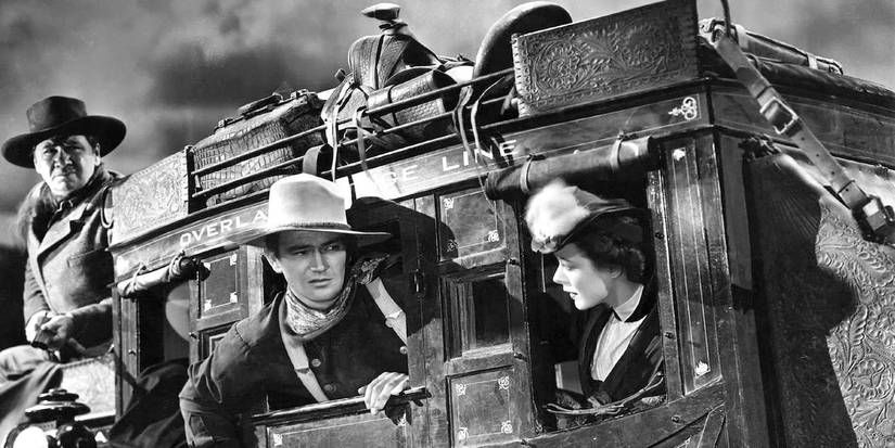 The cast of John Ford's Stagecoach (1939) John Wayne and cast all looking out of the stagecoach in western attire 