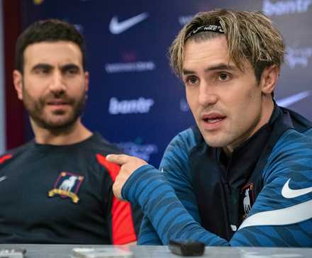 Jamie Tartt pointing at a shocked Roy Kent in a Ted Lasso press conference