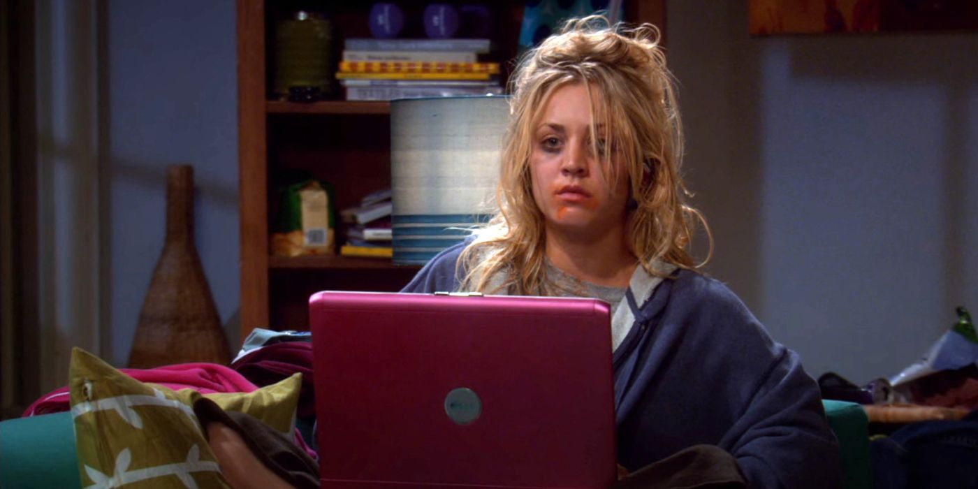Penny with messy hair gaming on her pink computer in The Big Bang Theory