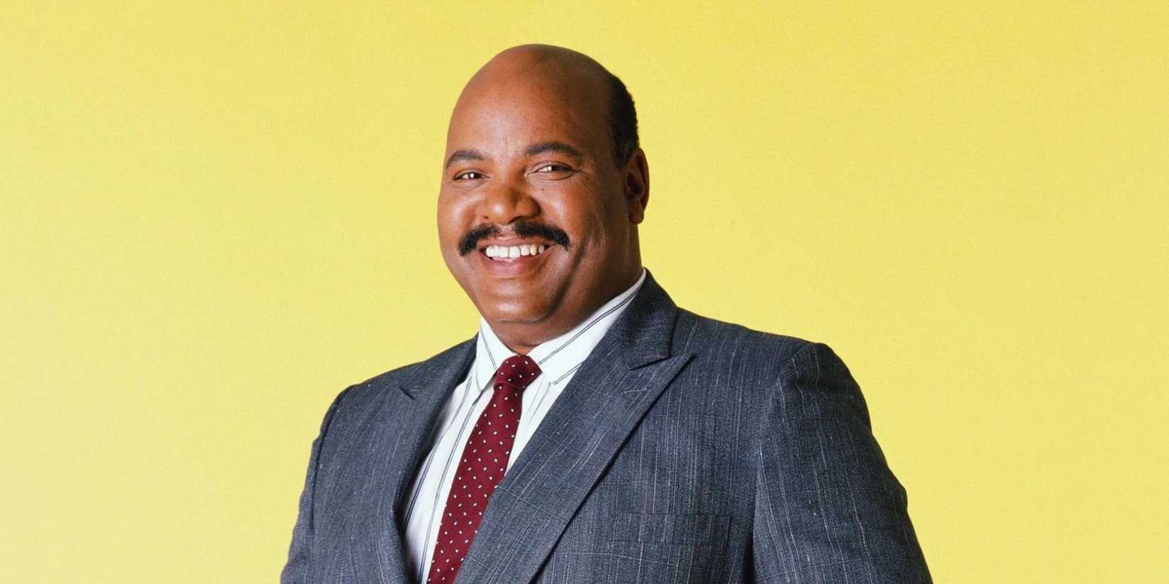 Uncle Phil posing in front of a yellow backdrop in The Fresh Prince of Bel-Air 