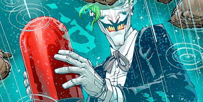 A wickedly smiling joker holding the original Red Hood helmet in the rain.