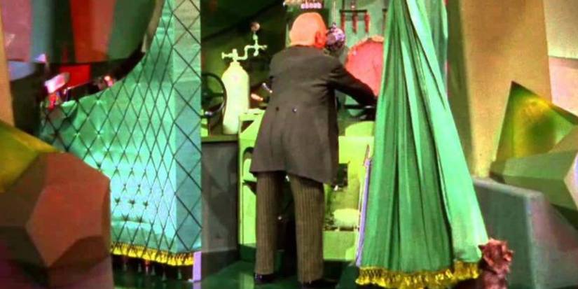 Toto pulls back the curtain to reveal the real form of the Wizard (Frank Morgan) in The Wizard of Oz.
