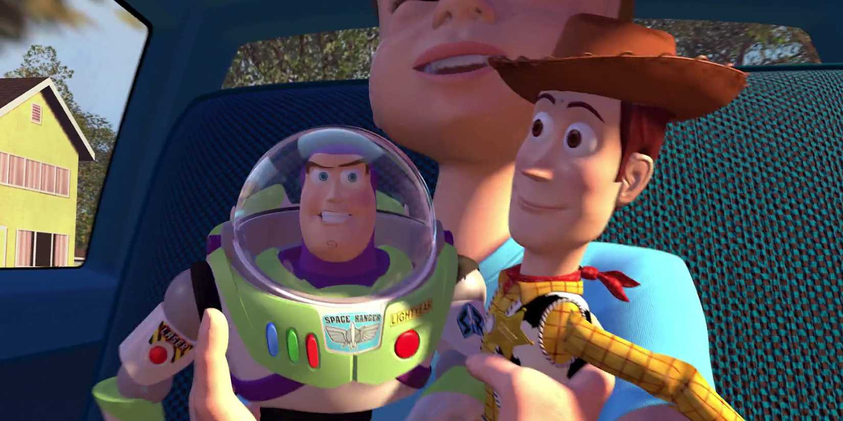 Andy holding Buzz and Woody in a car in Toy Story