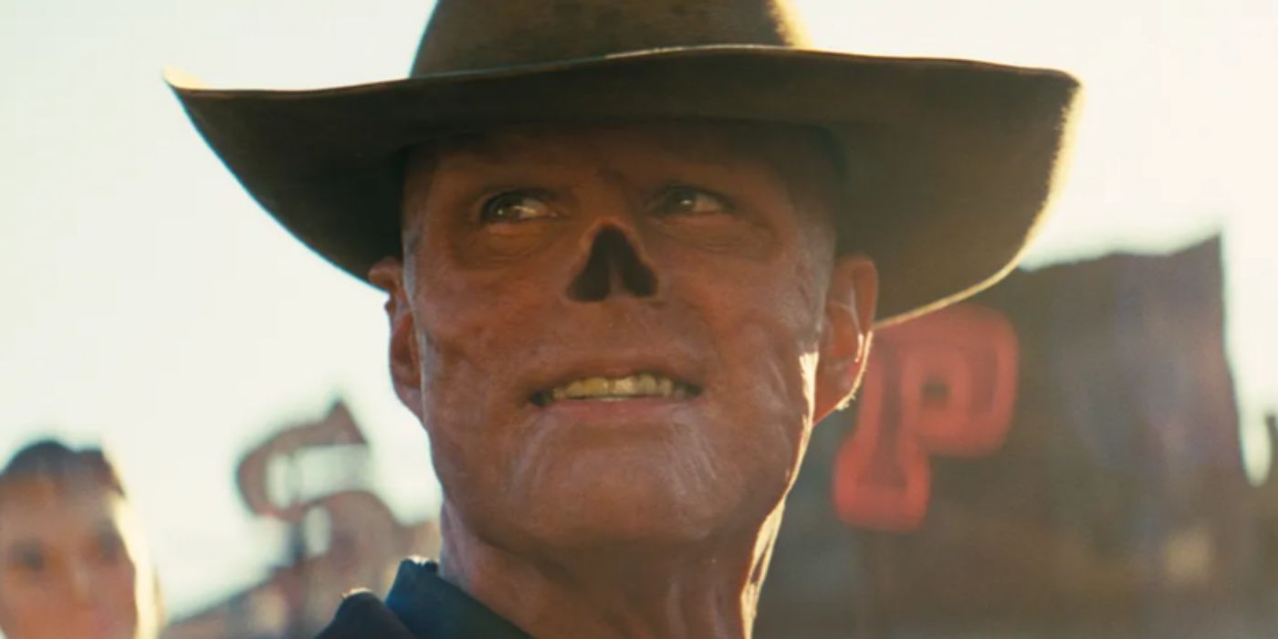 Walton Goggins as The Ghoul flashes a dastardly smile while looking off to the side in a dilapidated Western town in the live-action Fallout TV show