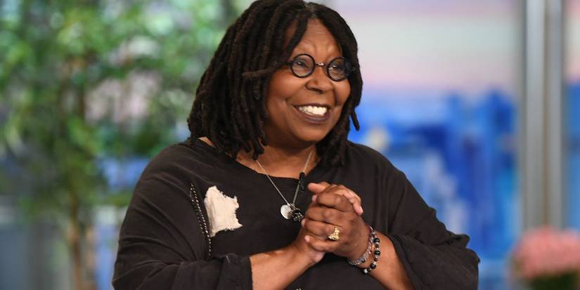 Whoopi Goldberg smiling and clapping in The View
