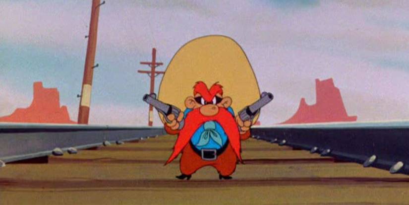 Yosemite Sam standing on train tracks pointing two revolvers at Bugs Bunny in 1945's Hare Trigger
