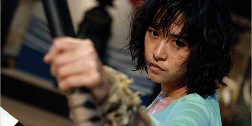 A battered and bruised Zen clutches on to a sheathed katana as she prepares for battle in 2008's Chocolate