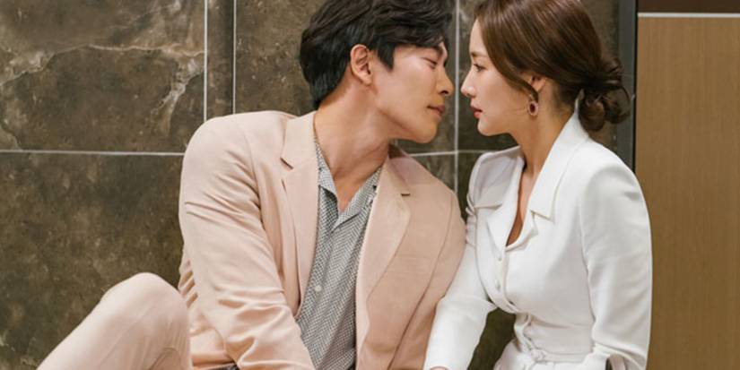 A man leans into a woman while the two sit on the floor in the K-drama Her Private Life