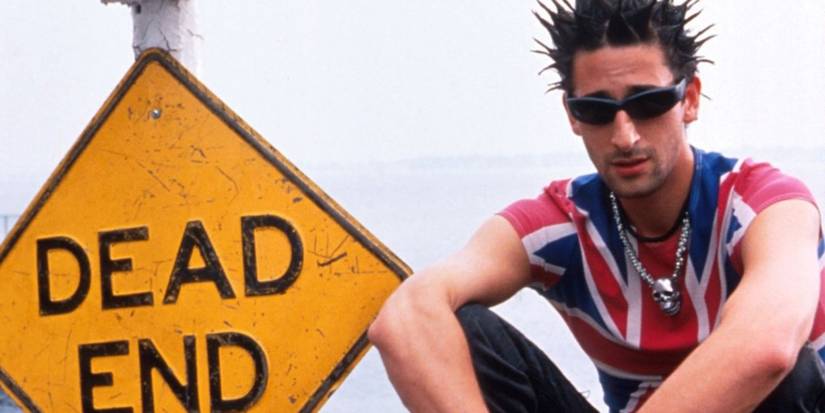Adrien Brodie as Ritchie seated next to a ᴅᴇᴀᴅ end sign in a promotional still for Summer of Sam