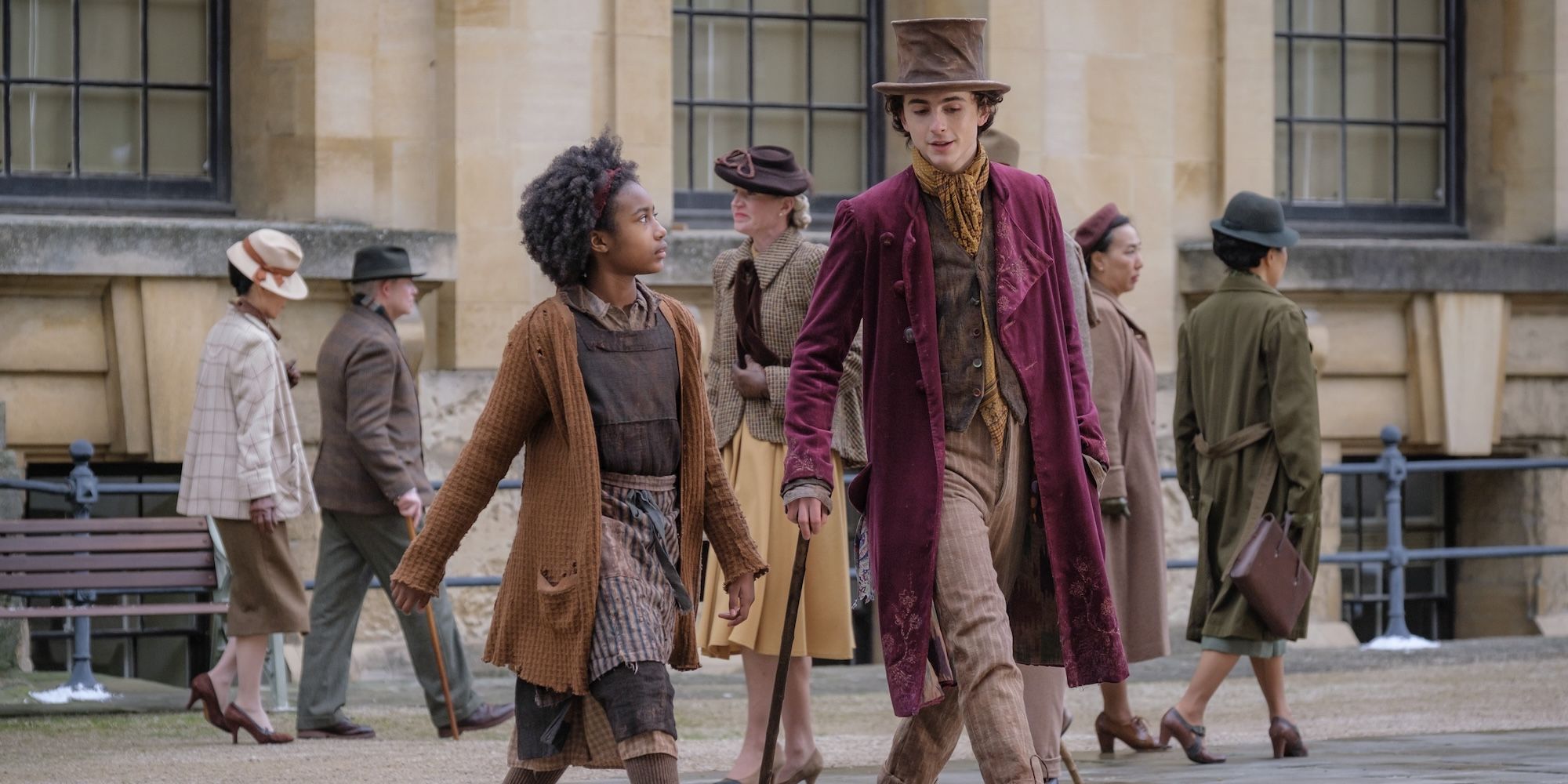 Calah Lane as Noodle and Timothée Chalamet as Wonka walking in Wonka