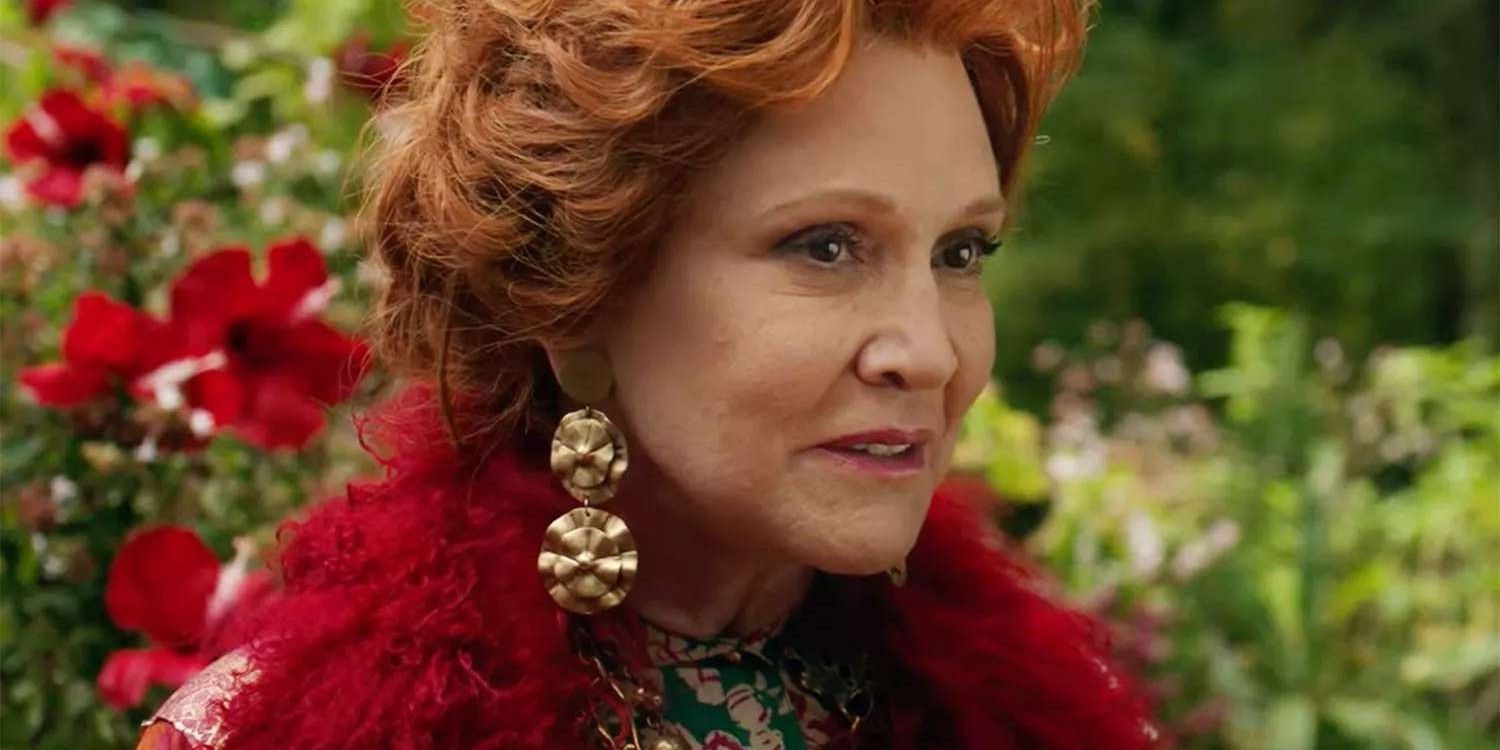 Carrie Fisher with red hair smiling in a magical garden in Wonderwell