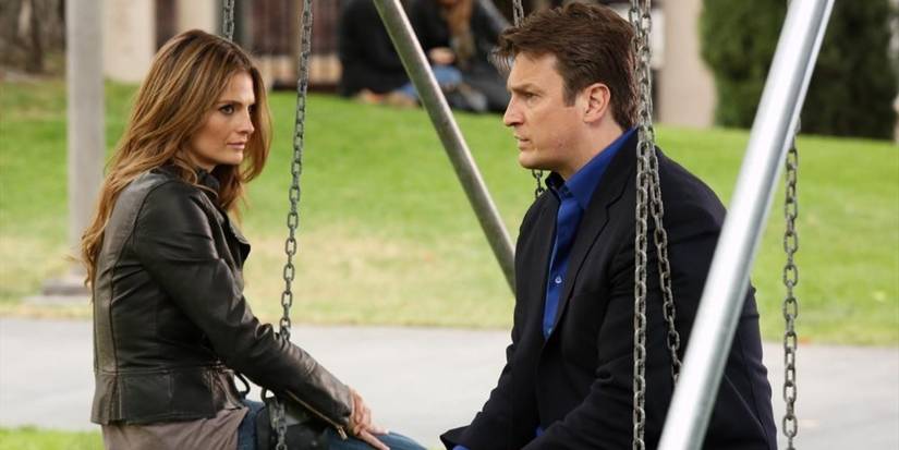Beckett and Castle on the swings in Castle 