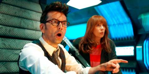 David Tennant and Catherine Tate as the Fourteenth Doctor and Donna looking shocked as they look at the command console in the Doctor Who episode 