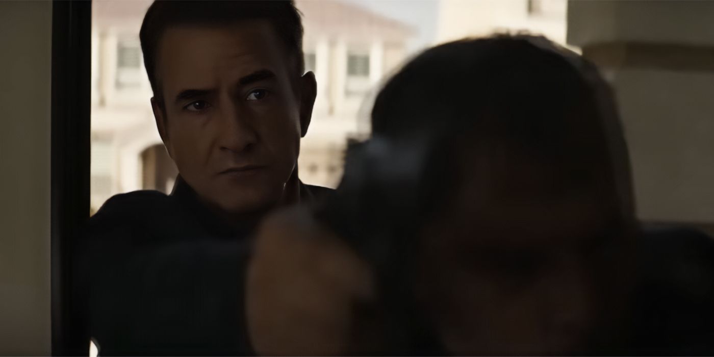 Dermot Mulroney as Harry holding a gun in Ruthless