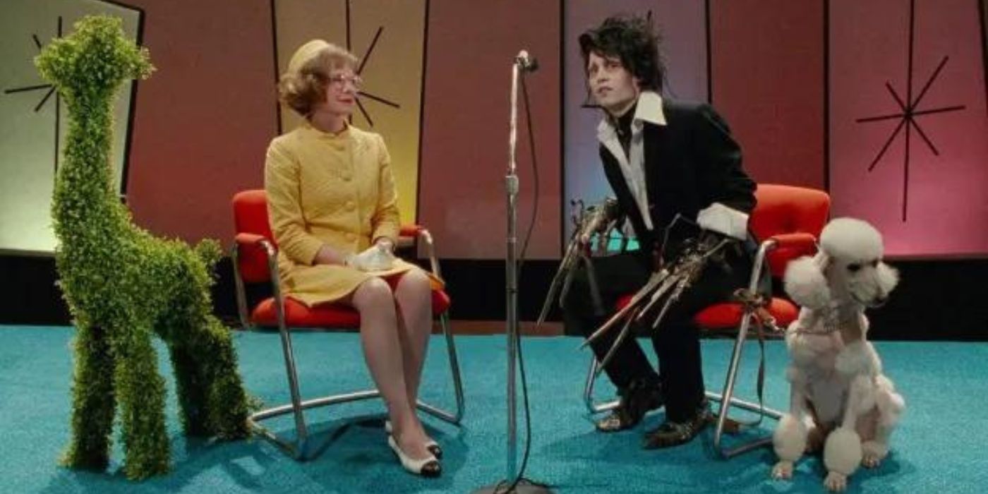 Edward awkwardly leans into a microphone while a poodle looks away in what appears to be a television show set in the 1960s in Edward Scissorhands