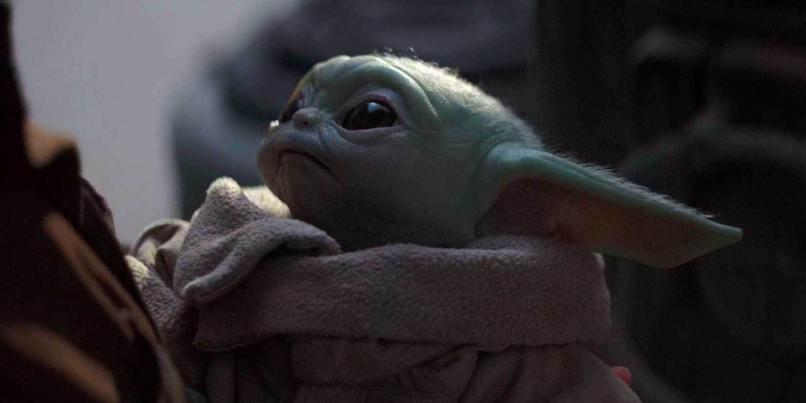 Grogu looks up at Peli Motto in The Mandalorian season 1