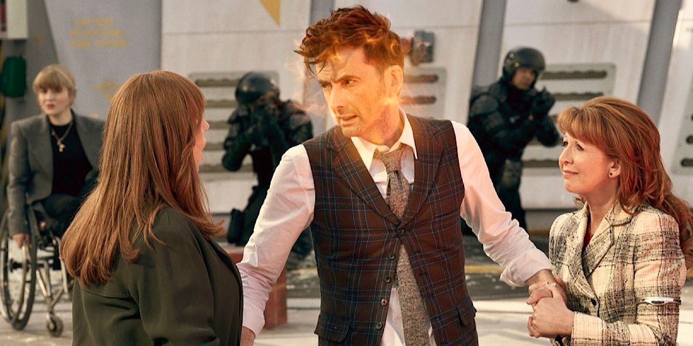 The Fourteenth Doctor regenerating with Donna and Mel holding his hands in Doctor Who.