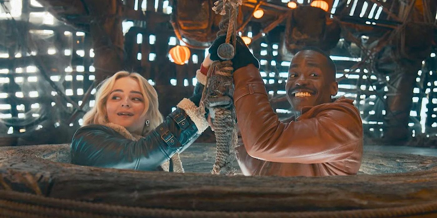 Millie Gibson as Ruby Sunday and Ncuti Gatwa as the Fifteenth Doctor holding onto a ladder at the entry hole of the Goblin's ship in Doctor Who