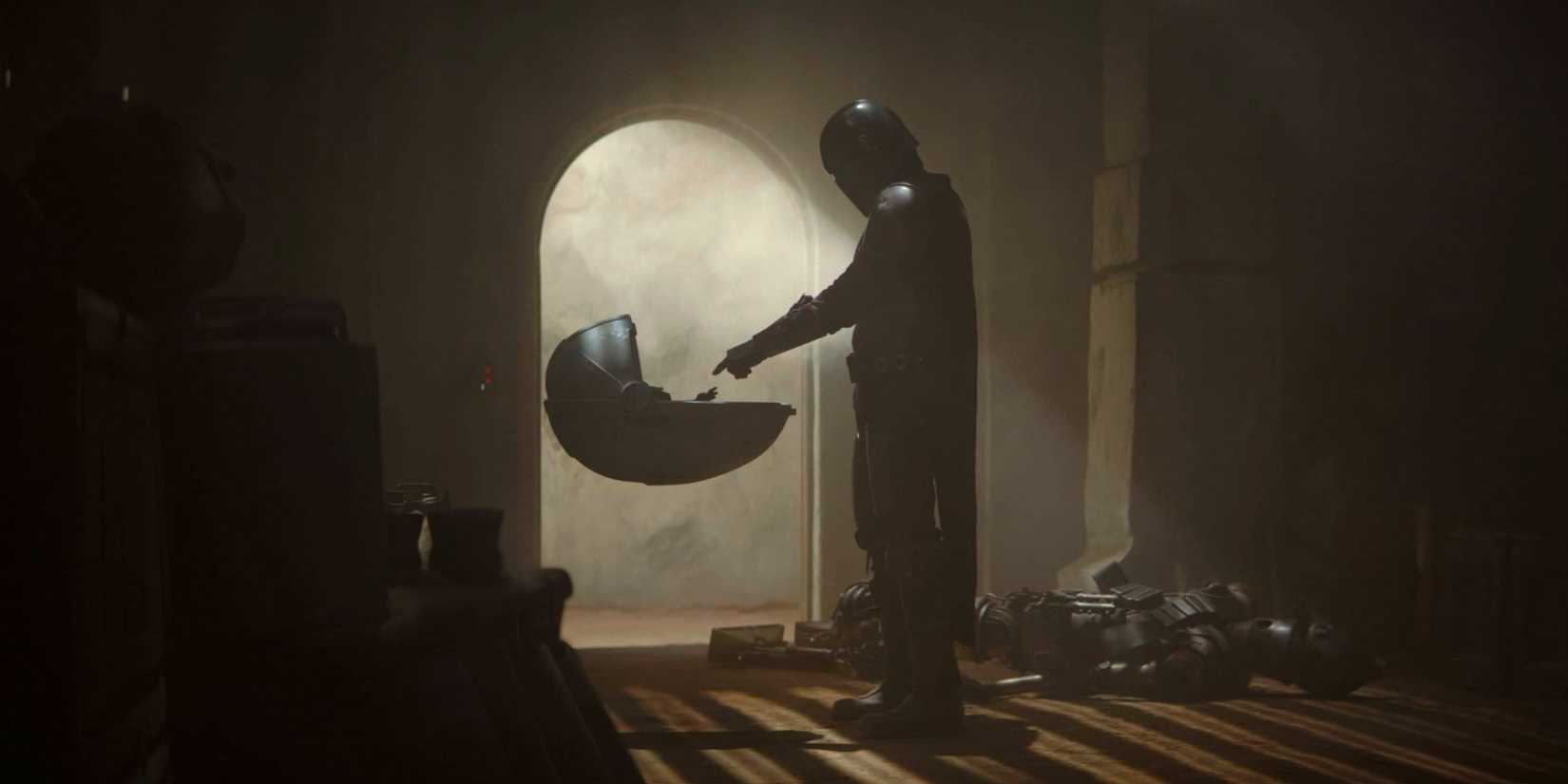 Din Djarin estende o dedo para Grogu em 'The Mandalorian'.