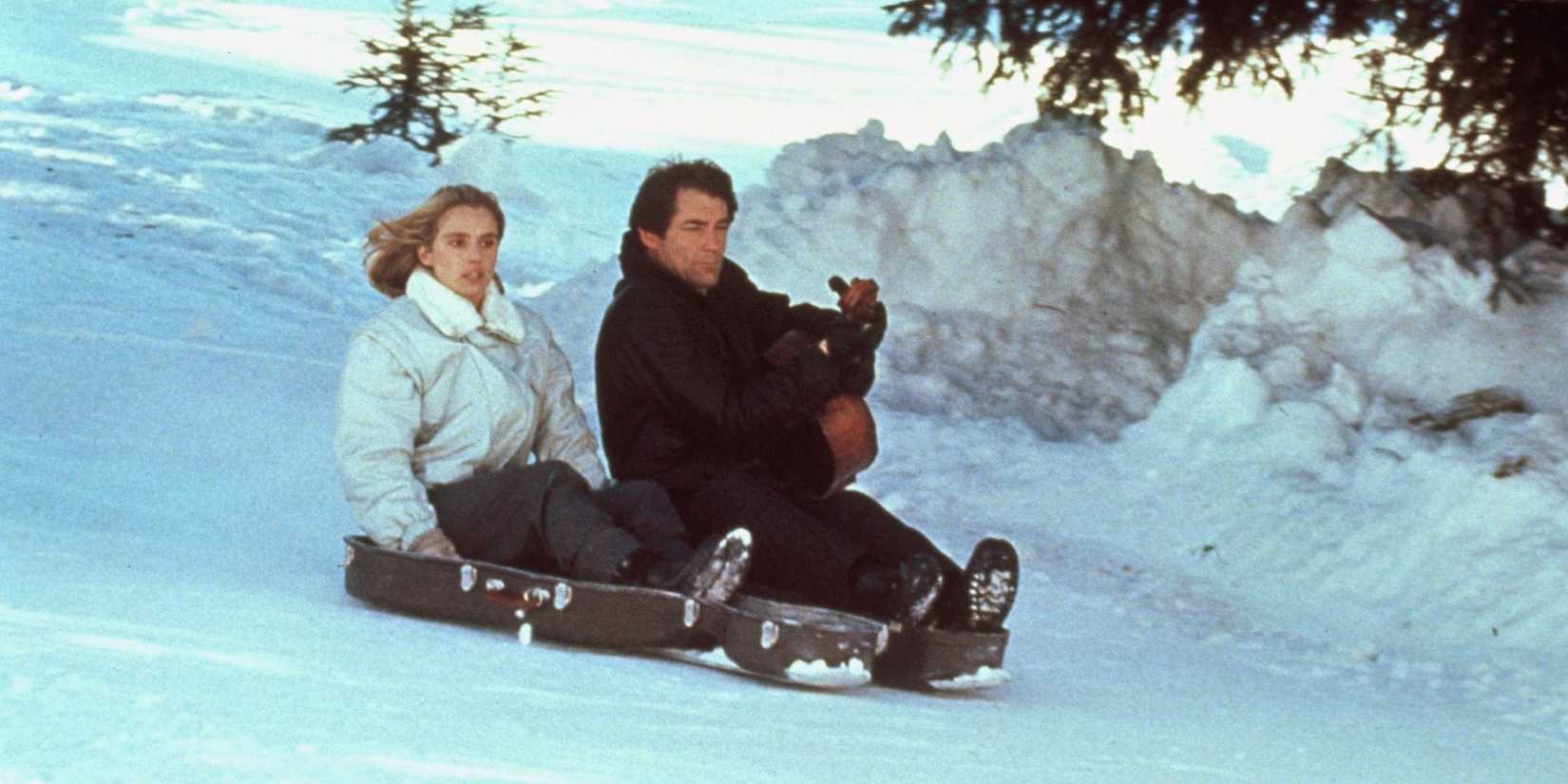 James Bond and Kara riding a cello case down the side of a mountain in The Living Daylights