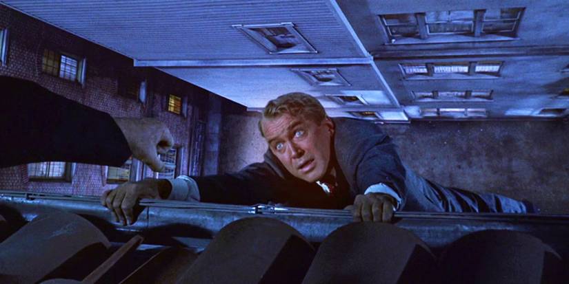 James Stewart as John Scottie Ferguson hanging from a building in Vertigo