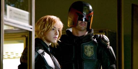 Judges Dredd and Anderson standing side by side and looking serious in Dredd