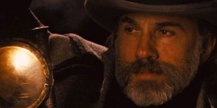 King Shultz holding a lantern up to Django's face in Django Unchained