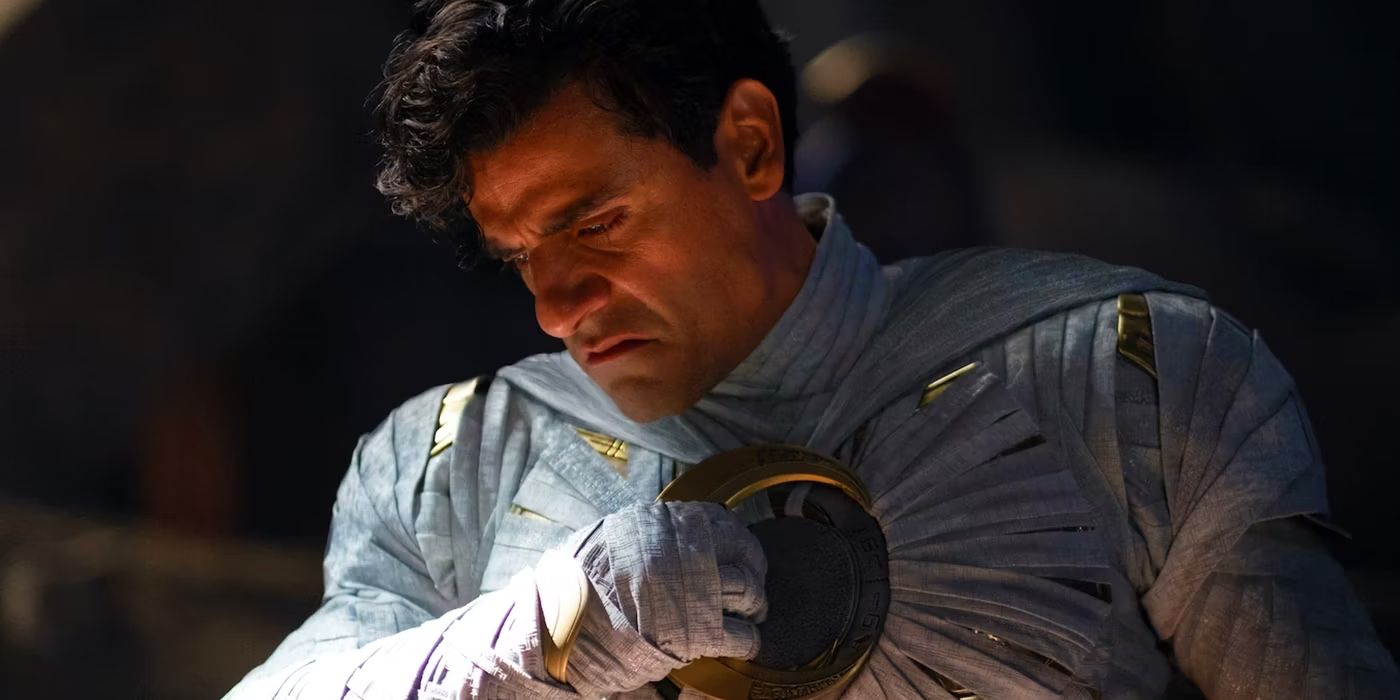Marc Spector (Oscar Isaac) holds his chest piece in Moon Knight