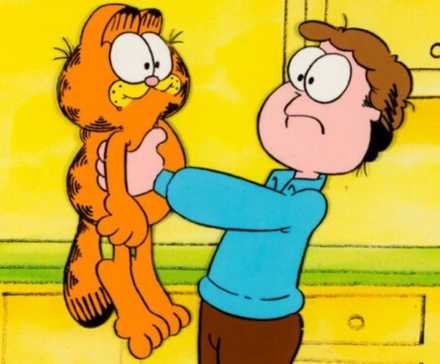 Jon Arbuckle holds up Garfield and the two look at each other blankly.