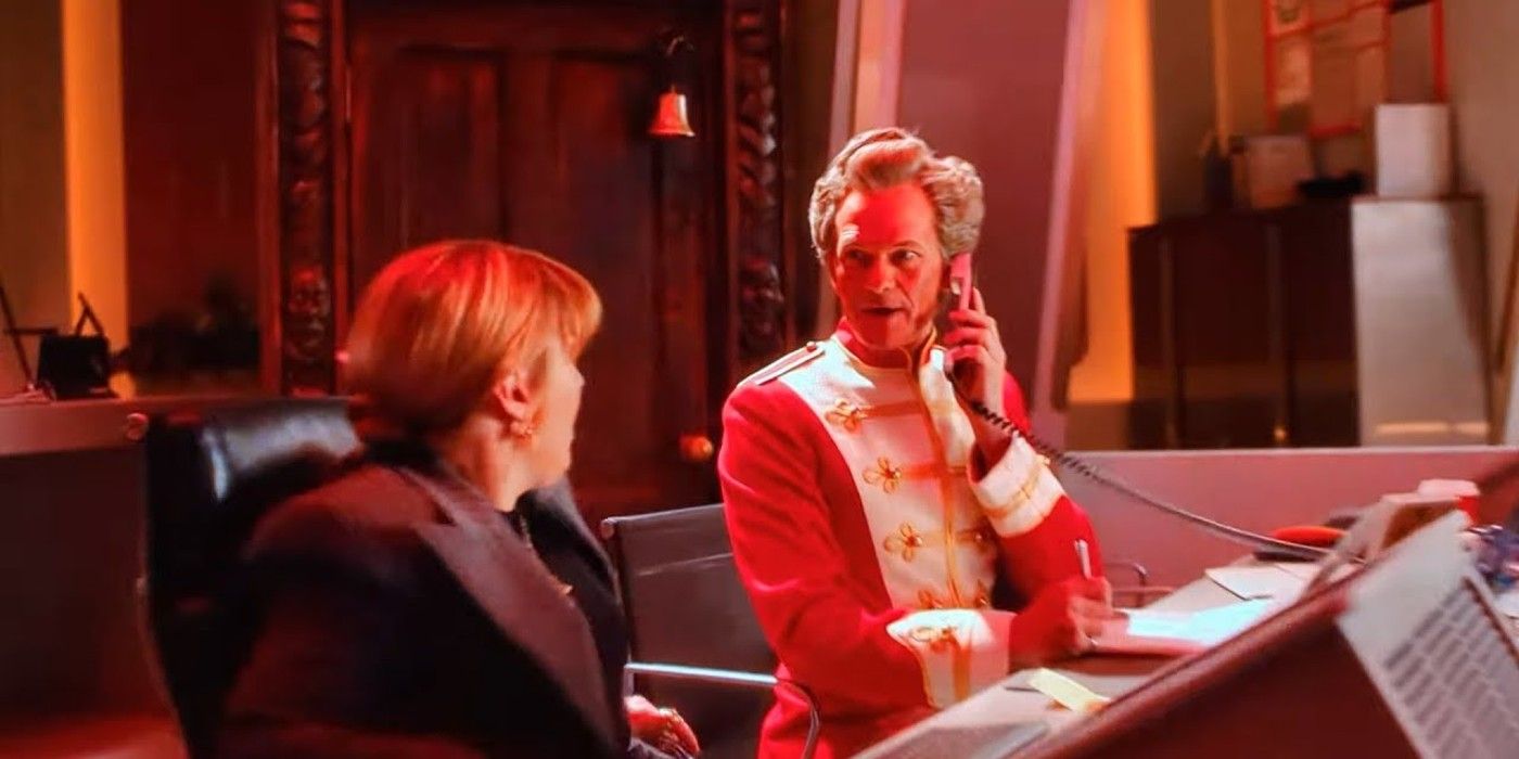 Neil Patrick Harris as the Toymaker on the phone facing Shirley in Doctor Who.