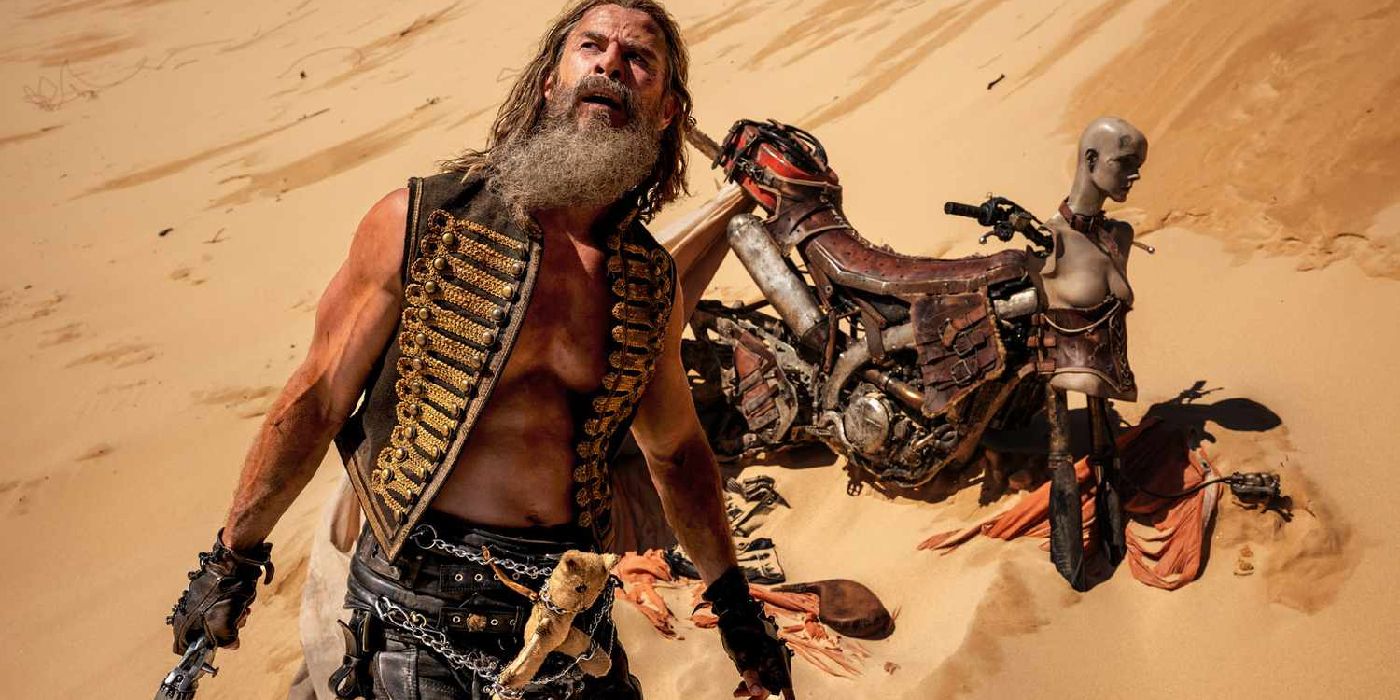 Chris Hemsworth in front of bike in the sand in Furiosa