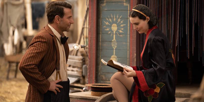 Bradley Cooper watching Rooney Mara who is reading a book in Nightmare Alley