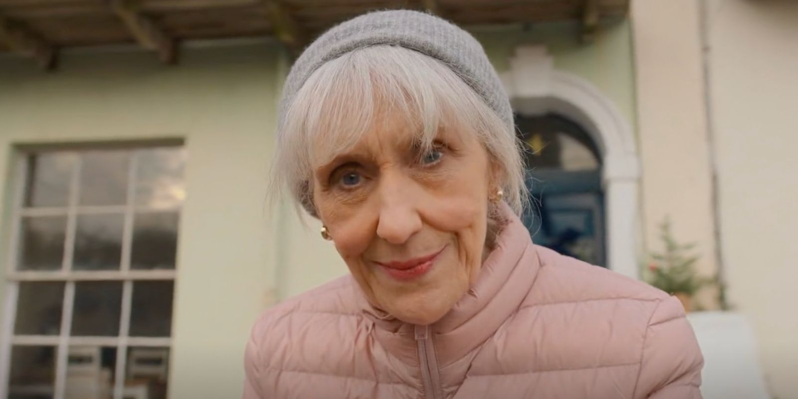 Anita Dobson as Mrs. Flood looking at the camera smiling in Doctor Who 2023 Christmas special The Church on Ruby Road.