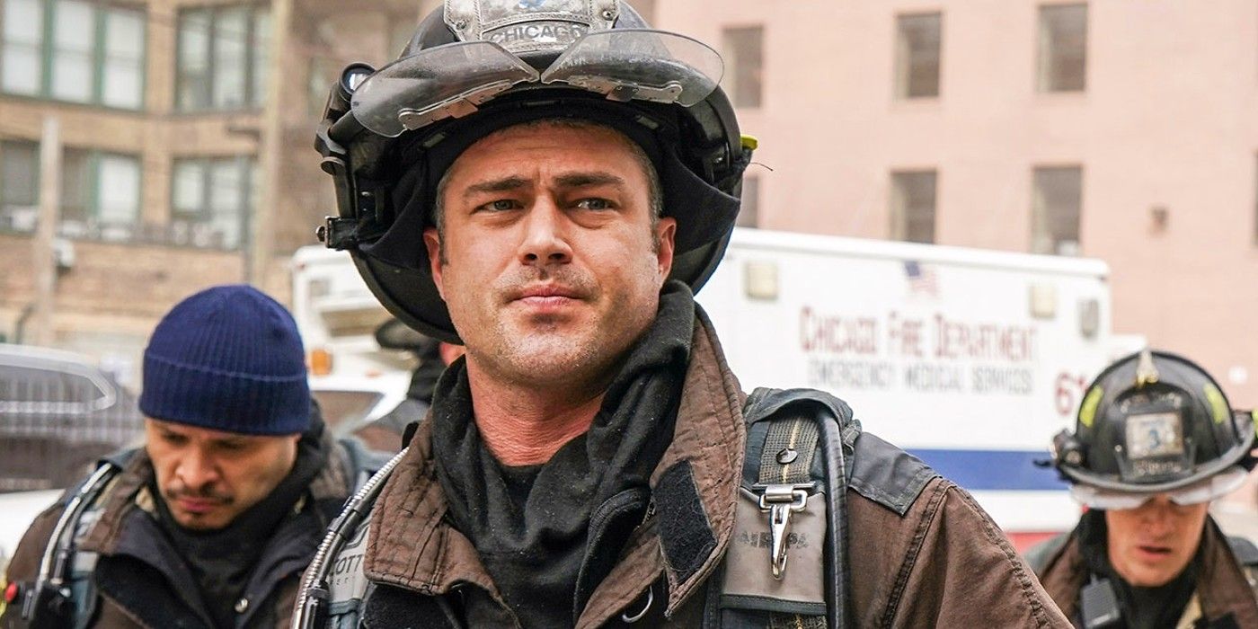 Taylor Kinney as Severide dressed in his firefighter suit standing outside in Chicago Fire