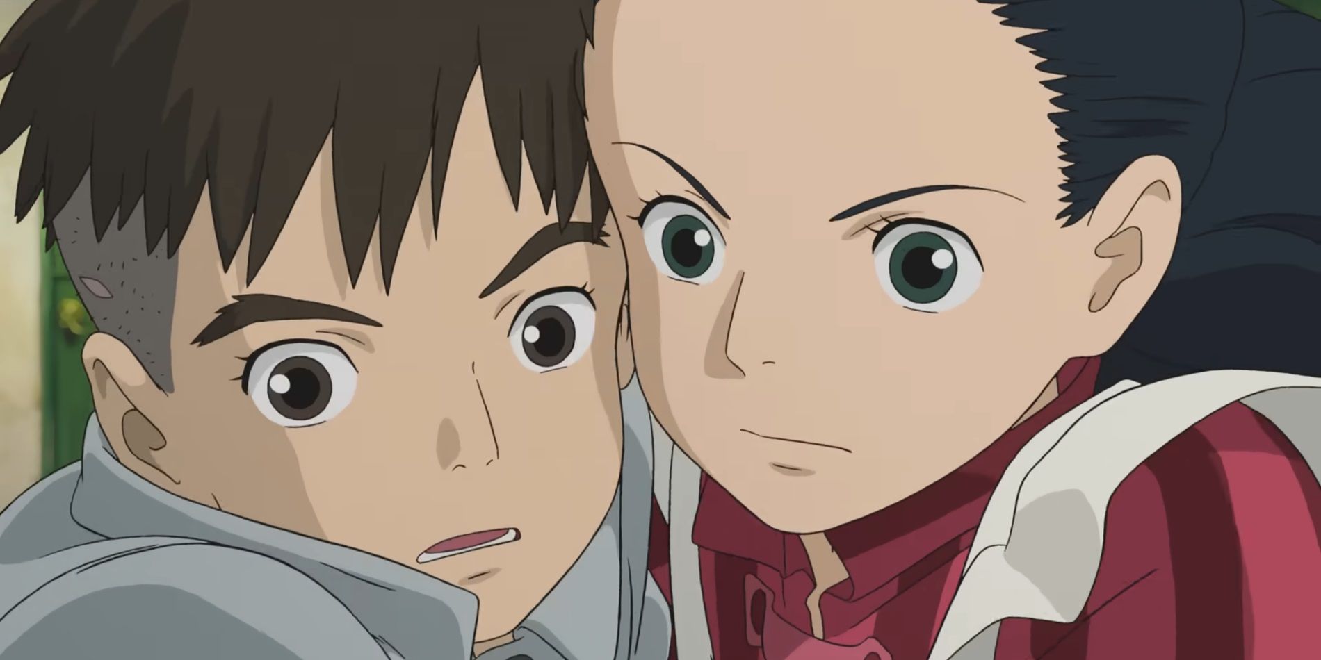 Mahito and Himi in The Boy and he Heron with their faces pressed together.