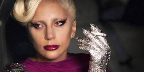 The Countess smoking and looking out of a car window in American Horror Story Hotel