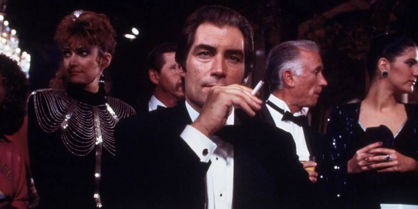 Timothy Dalton as James Bond holding a cigarette in License to Kill.