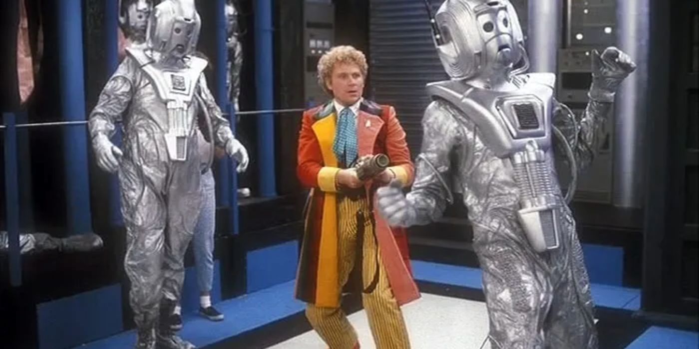The Sixth Doctor (Colin Baker) aims a cyber-gun at a cyberman