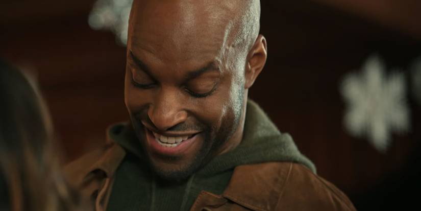 Preacher laughs while talking to Kaia in Virgin River's Christmas episodes