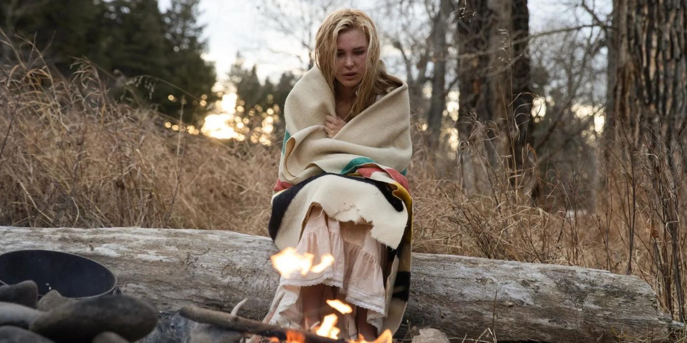 Elsa Dutton wrapped in a blanket and staring at a fire in 1883's finale