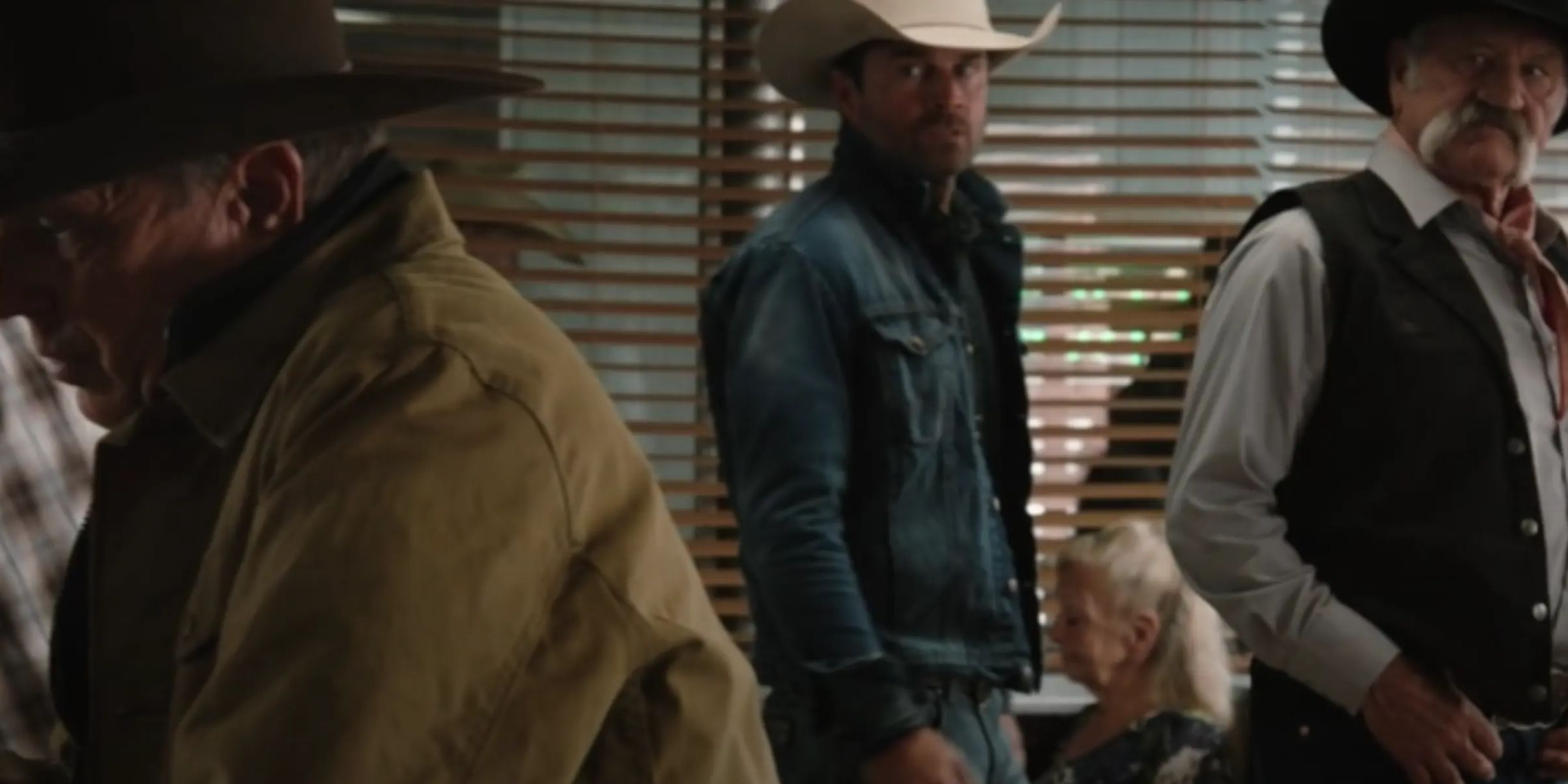 Wade Morrow and his son looking at John Dutton in a diner in Yellowstone