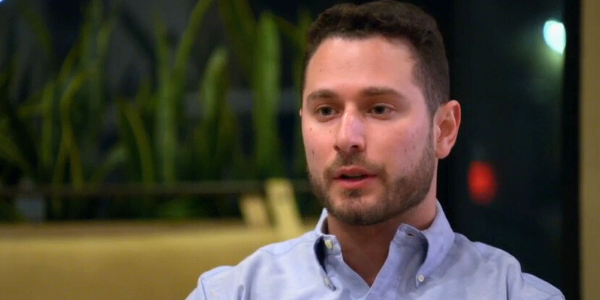 Brennan from Married at First Sight Season 17 talking in blue shirt to expert