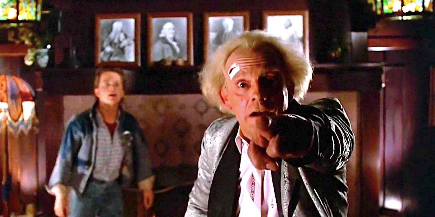 Christopher Lloyd's Doc Brown points at the camera as Michael J Fox's Marty looks on in the background in Back to the Future