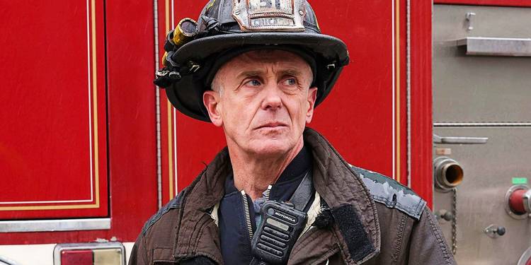 David Eigenberg as Hermann standing by a fire truck in Chicago Fire